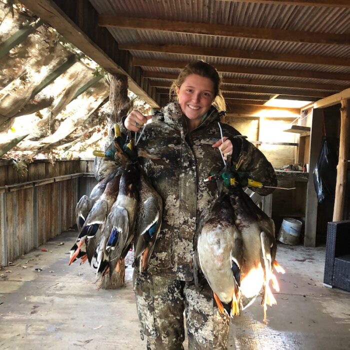 hunter holding ducks